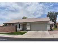 Charming single-story home featuring a tile roof, desert landscaping, and a spacious two-car garage at 2221 E Union Hills Dr # 148, Phoenix, AZ 85024