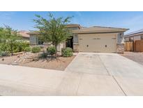 Charming single-story home with a well-maintained front yard and a two-car garage at 26032 W Quail Ave, Buckeye, AZ 85396