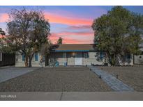 Charming single-story home featuring desert landscaping and a welcoming front porch under a colorful sunset at 2731 N 23Rd Ave, Phoenix, AZ 85009