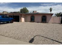 Charming single-story home with a low-maintenance rock yard and arched windows at 2840 W Marlette Ave, Phoenix, AZ 85017