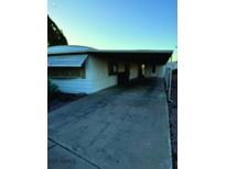 Charming single-story home featuring a covered parking and well-maintained landscape at 3104 E Broadway Rd # 295, Mesa, AZ 85204