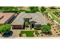 Beautiful two-story home with a well-manicured lawn, mature trees, and a charming stone entrance at 3400 S Whetstone Pl, Chandler, AZ 85286