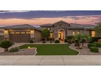 Charming single-Gathering home featuring a stone archway, well-manicured landscaping, and a welcoming two-car garage at 3400 S Whetstone Pl, Chandler, AZ 85286
