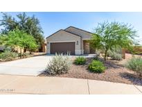 Charming single-story home featuring a well-maintained yard with desert landscaping and a two-car garage at 36625 W Montserrat St, Maricopa, AZ 85138