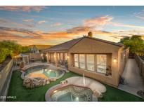 Gorgeous backyard with pool, spa, and lovely sunset at 4281 S Tecoma Trl, Gold Canyon, AZ 85118