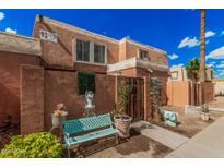 Charming townhome featuring a private front patio and beautifully landscaped entrance at 4434 E Wood St, Phoenix, AZ 85040