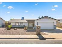 Charming single-story home featuring a manicured front yard and a two-car garage at 4645 E Covina St, Mesa, AZ 85205