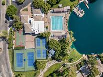 Stunning aerial view of the lake community, showcasing pool, tennis courts, and boat docks for an active lifestyle at 5200 S Lakeshore Dr # 120, Tempe, AZ 85283