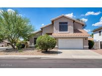 Charming two-story home featuring a well-manicured front yard and a two car garage at 7456 W Via Montoya Dr, Glendale, AZ 85310