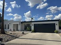 Charming single-story home with desert landscaping, a two-car garage, and a bright-white exterior at 842 E Village Circle N Dr, Phoenix, AZ 85022