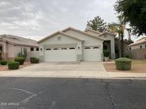 Charming single-story home featuring a three car garage and desert landscaping at 9337 E Kiva Ave, Mesa, AZ 85209