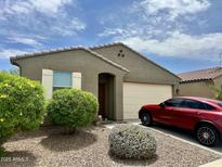 Charming home featuring a desert landscape, covered entry, neutral color scheme and a two car garage at 9825 W Trumbull Rd, Tolleson, AZ 85353