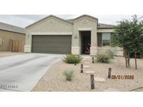 Charming single-story home with desert landscaping, walkway lights, and a two-car garage at 1246 E Thomas Dr, Casa Grande, AZ 85122