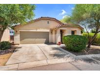 Charming single-story home with a two-car garage, desert landscaping, and a welcoming entrance at 1314 S Bridgegate Dr, Gilbert, AZ 85296