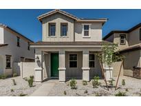 Charming two-story home showcasing a welcoming front porch with a vibrant green door at 15593 S 180Th Ln, Goodyear, AZ 85338