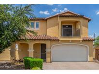 Inviting two-story home with a charming front porch and a two-car garage at 2046 E Paradise Ln, Phoenix, AZ 85022
