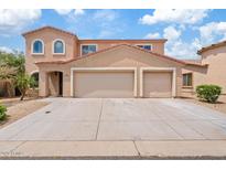 Charming home featuring a three-car garage and arched windows at 2286 E Mohave Ln, Apache Junction, AZ 85119