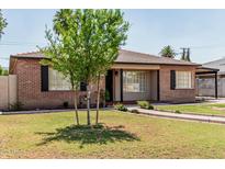 Attractive brick home with a tile roof, covered parking, mature trees, and landscaped front yard at 2807 N 8Th Ave, Phoenix, AZ 85007