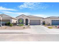 Charming single-story home with a two-car garage, landscaped front yard, and neutral color palette at 40816 W Sunland Dr, Maricopa, AZ 85138