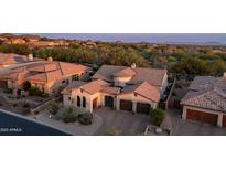 Stunning home with a clay tile roof, beautiful landscaping, and charming curb appeal at sunset at 7841 E Stonecliff Cir, Mesa, AZ 85207