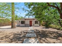 Charming home with a red front door, gravel landscaping, and walkway pavers at 1117 W Glenrosa Ave, Phoenix, AZ 85013