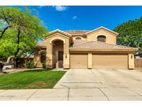Inviting two-story home with a well-manicured lawn and a three-car garage at 1268 N Pine St, Gilbert, AZ 85233