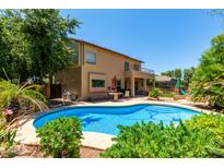 Beautiful backyard oasis featuring a refreshing pool, patio, and lush landscaping, perfect for outdoor entertaining at 194 E Canyon Creek Dr, Gilbert, AZ 85295