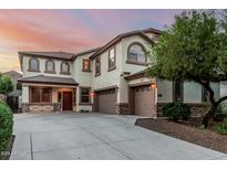 Charming two-story home with a three-car garage, beautiful windows, and a well-maintained yard at 2556 E Quiet Hollow Ln, Phoenix, AZ 85024