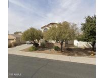 Charming two-story home with a stucco facade, well-maintained landscaping, and a welcoming entrance at 2556 E Quiet Hollow Ln, Phoenix, AZ 85024