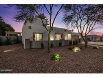 Charming single story home featuring desert landscaping, privacy wall, and picturesque setting at sunset at 5309 E Hearn Rd, Scottsdale, AZ 85254
