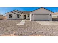 Charming single-story home with a well-maintained yard and attached two-car garage, perfect for Gathering living at 5499 E Red Bird Ln, San Tan Valley, AZ 85140