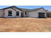 New construction features a white stucco exterior, dark grey trim, and a spacious two-car garage at 5499 E Red Bird Ln, San Tan Valley, AZ 85140
