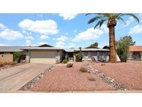 Inviting single-Gathering home featuring a desert-landscaped front yard with a mature palm tree at 7120 N Via De La Sendero --, Scottsdale, AZ 85258