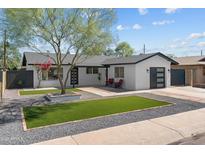 Charming single-story home with modern updates and a well-manicured front yard at 8732 E Arlington Rd, Scottsdale, AZ 85250