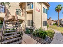 Attractive condo building with desert landscaping, private entrances, and staircase access at 930 N Mesa Dr # 1023, Mesa, AZ 85201
