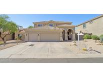 Two-story home boasts a three-car garage and desert landscaping at 10448 E Conieson Rd, Scottsdale, AZ 85255