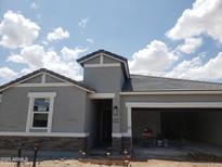 Charming single-story home featuring gray stucco, stone accents, and an attached two-car garage at 18809 E Bruno Dr, Gold Canyon, AZ 85118
