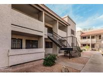 Exterior shot of a well maintained two-story condo building with exterior stairwell at 234 N 75Th St # 209, Mesa, AZ 85207