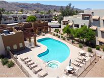 Community swimming pool and hot tub with lounge chairs and tables are inviting and refreshing at 3434 E Baseline Rd # 216, Phoenix, AZ 85042