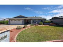 Charming single-story home with manicured lawn, lovely landscaping, and a two car garage at 3608 W Villa Rita Dr, Glendale, AZ 85308