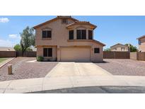 Two-story stucco home featuring a neutral color palette, desert landscaping, and an attached two-car garage at 9243 W Palmer Dr, Peoria, AZ 85345