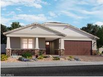 Charming single-story home featuring a two-car garage, landscaped front yard, and stone veneer accents at 15918 W El Cortez Pl, Surprise, AZ 85387