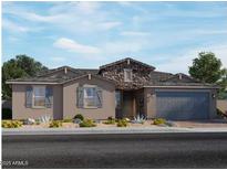 Charming single-story home with stone accents, a well-maintained yard, and a two-car garage at 15933 W El Cortez Pl, Surprise, AZ 85387