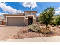 Charming single-story home featuring a stone facade, well-maintained landscaping, and a spacious two-car garage at 16221 W Prickly Pear Trl, Surprise, AZ 85387