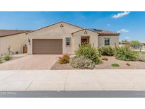 Charming single-story home with low maintenance desert landscaping and brick driveway, presenting inviting curb appeal at 17886 W Brookwood Dr, Goodyear, AZ 85338
