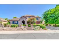 Charming two-story home featuring a stone-accented facade, landscaped yard, and inviting entrance at 2383 E Zion Way, Chandler, AZ 85249
