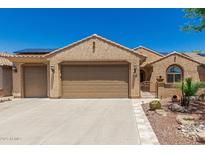 Charming home featuring a well-manicured desert landscape, a two-car garage, and a tile roof at 27244 W Potter Dr, Buckeye, AZ 85396