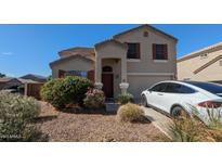 Charming home with a well-maintained front yard, red shutters, and a Tesla in the driveway at 4730 N 111Th Ln, Phoenix, AZ 85037
