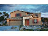 Inviting two-story home featuring a stone facade, red shutters, desert landscaping, and a two car garage at 5355 W Sweet Pea Ter, Laveen, AZ 85339