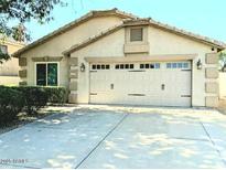 Charming home featuring a two-car garage, manicured landscaping, and a private driveway at 7435 W Trails Dr, Glendale, AZ 85308